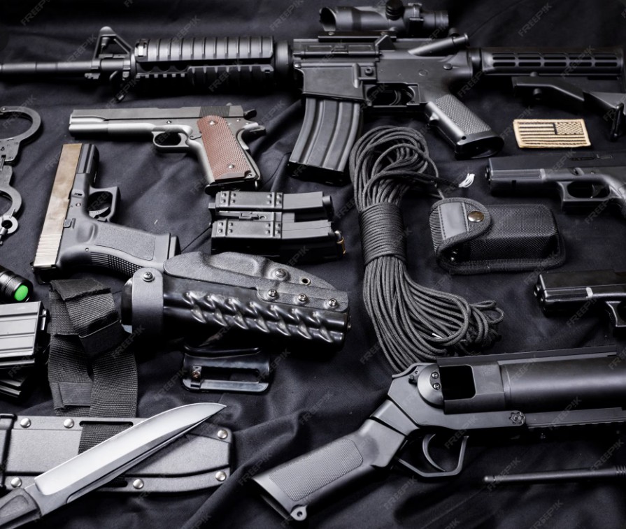 A collection of firearms on a dark background.